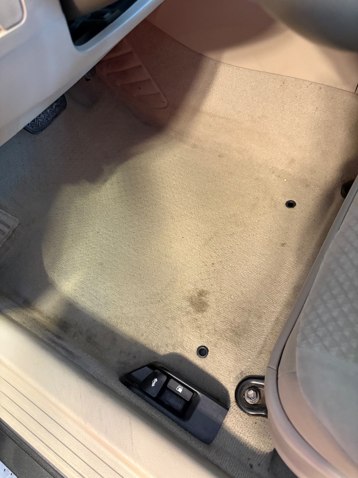 Stained, dirty driver-side carpet before detailing