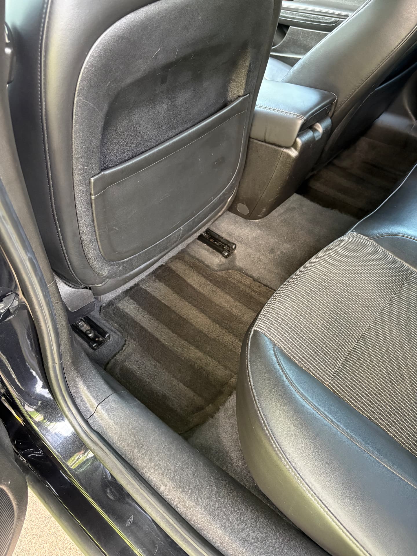 Detailed leather seat back, center console, and cleaned carpet